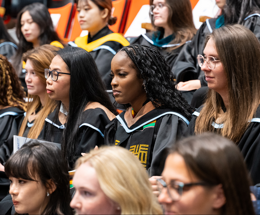 Tourism and Hospitality Management students sitting in the auditorium during the Fall 2024 graduation ceremony. 