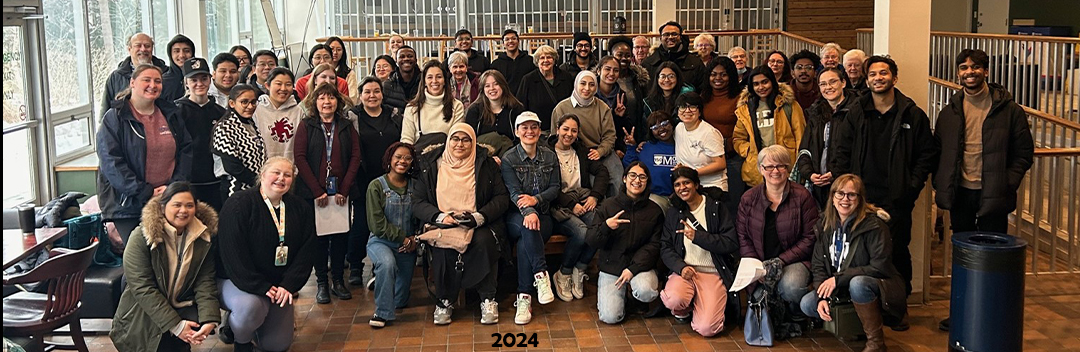 Mount Saint Vincent University's Business and Tourism students who volunteered for the department Caritas Day opportunities are standing all together for a group photo inside of the pub before they went out in the community. They all look pretty excited to be doing this.