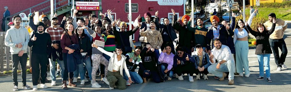 Students from the fall 2024 sustainable business tour standing in a line outside of the fisheries museum at the end of their day.