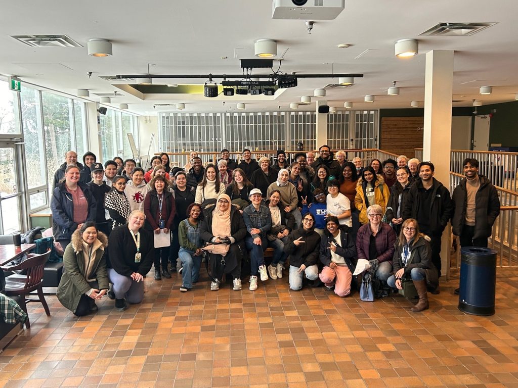 Mount Saint Vincent University's Business and Tourism students who volunteered for the department Caritas Day opportunities are standing all together for a group photo inside of the pub before they went out in the community. They all look pretty excited to be doing this.