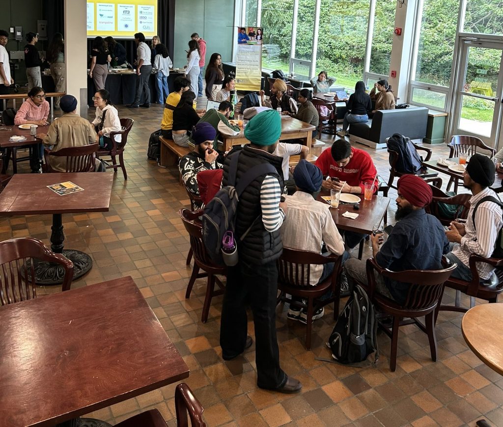 Room view of the pub with students eating pizza at the Business and Tourism Society Pizza Social. September 2024.