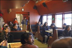 Business and Tourism students sitting in train car at Pier 21 in Halifax while on the Local Entrepreneur and Cultural tour 2025. 