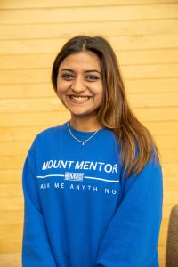 Simranpreet is wearing a royal blue Mount Mentors Ask Me Anything long-sleeved shirt.