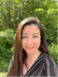 A headshot picture of Cynthia Urtubia smiling at the camera. 