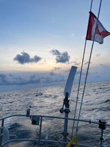 A view of the Atlantic ocean as seen on a fishing boat, with the Canada flag hoisted on the back of the boat