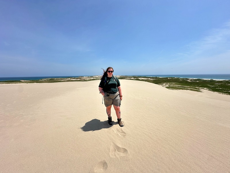 Alyssa Rose standing on a sand dune