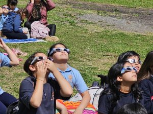 Students from East St. Margaret's Consolidated Elementary School watching the eclipse