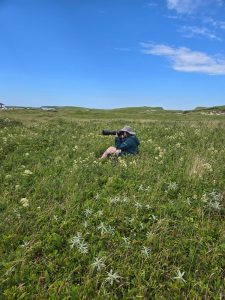 Alyssa Rose taking photos in a large field