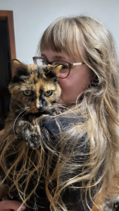 Catherine Walker cuddling her cat Tito