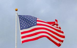 An American Flag waving on a flagpost