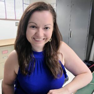 Kathryn Reeve, smiling for the camera in a blue dress