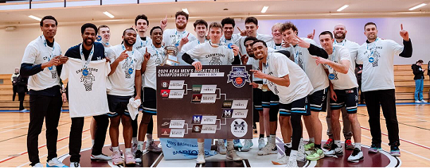 The MSVU Men's basketball team holding the ACAA championship banner