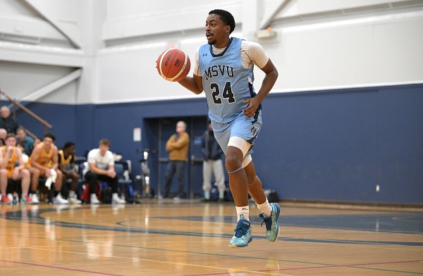 Jaxon Smith holding a basketball during a game