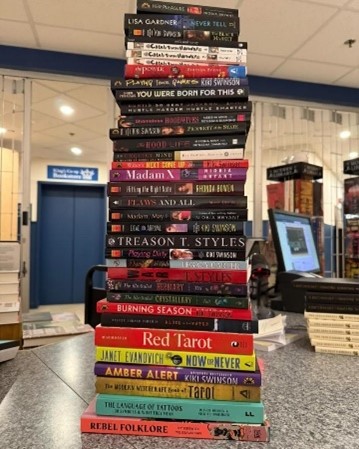 A stack of books being donated to Books Beyond Bars